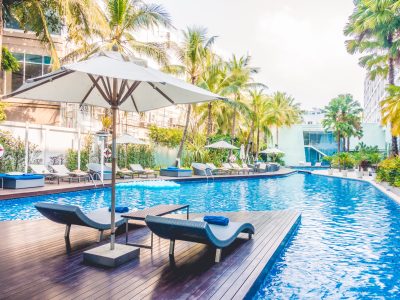 Umbrella pool and chair around beautiful luxury swimming pool in hotel resort - Vintage Light film Filter